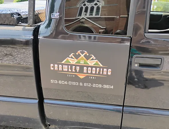 A car door with branding of Crawley Roofing LLC